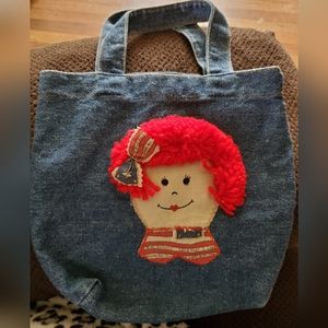 NWOT RAGGEDY ANN BLUE JEAN PURSE. 10" WITHOUT STRAP & 15" WITH STRAP.